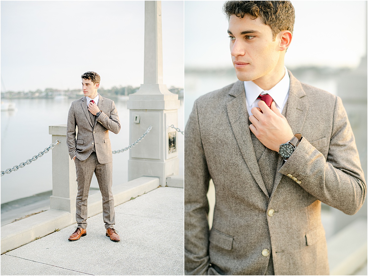 groom posing by the water for portraits
