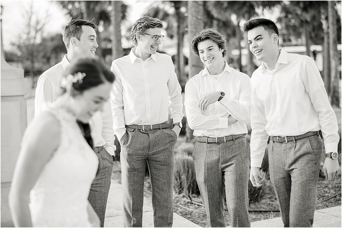 black and white image of the groomsmen seeing the bride for the first time