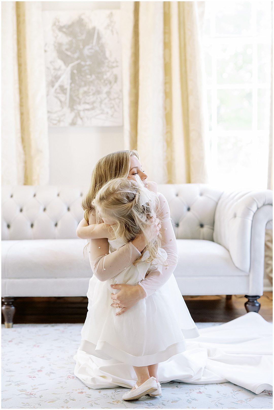 bride and flower girl hugging
