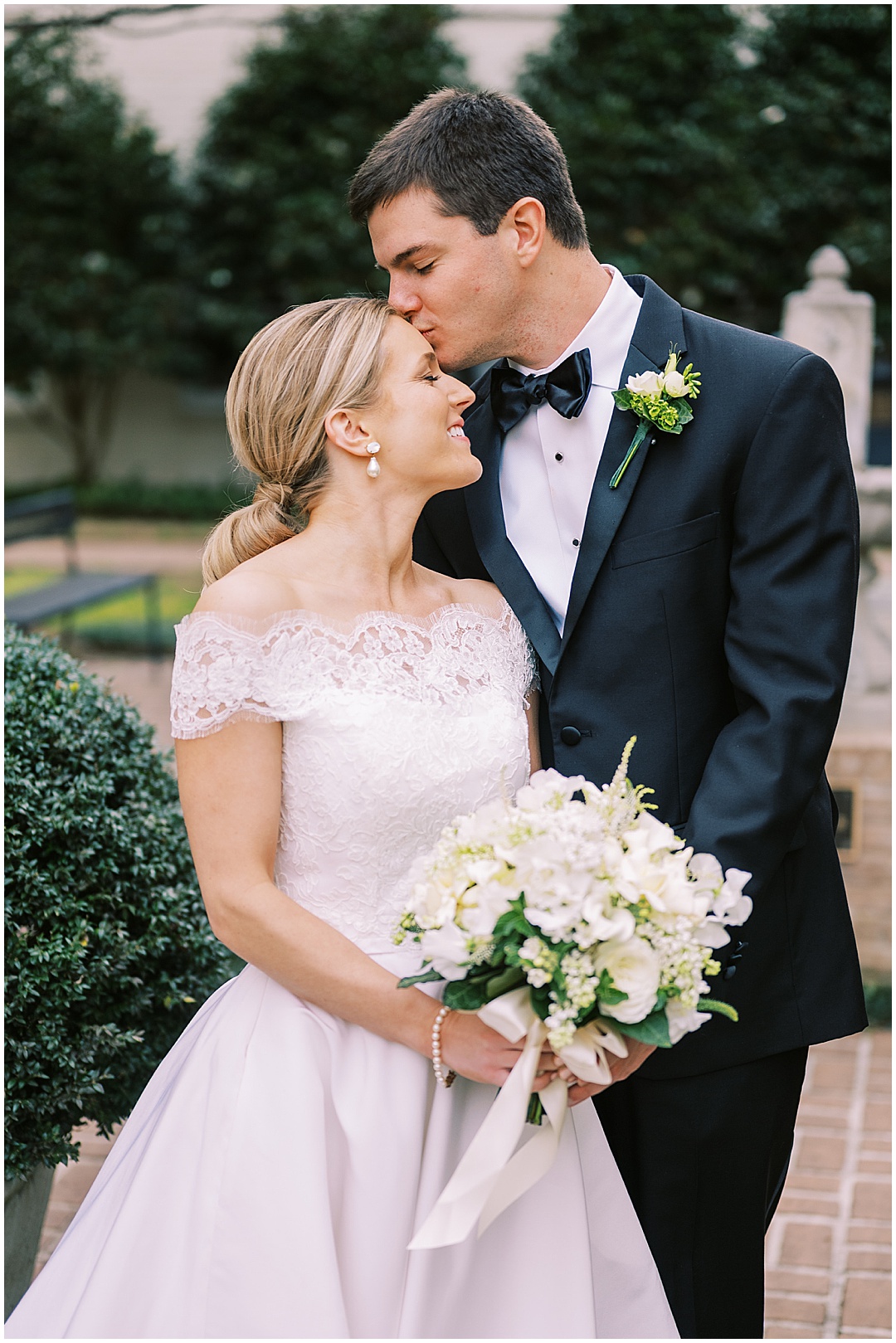 groom kissing bride forehead