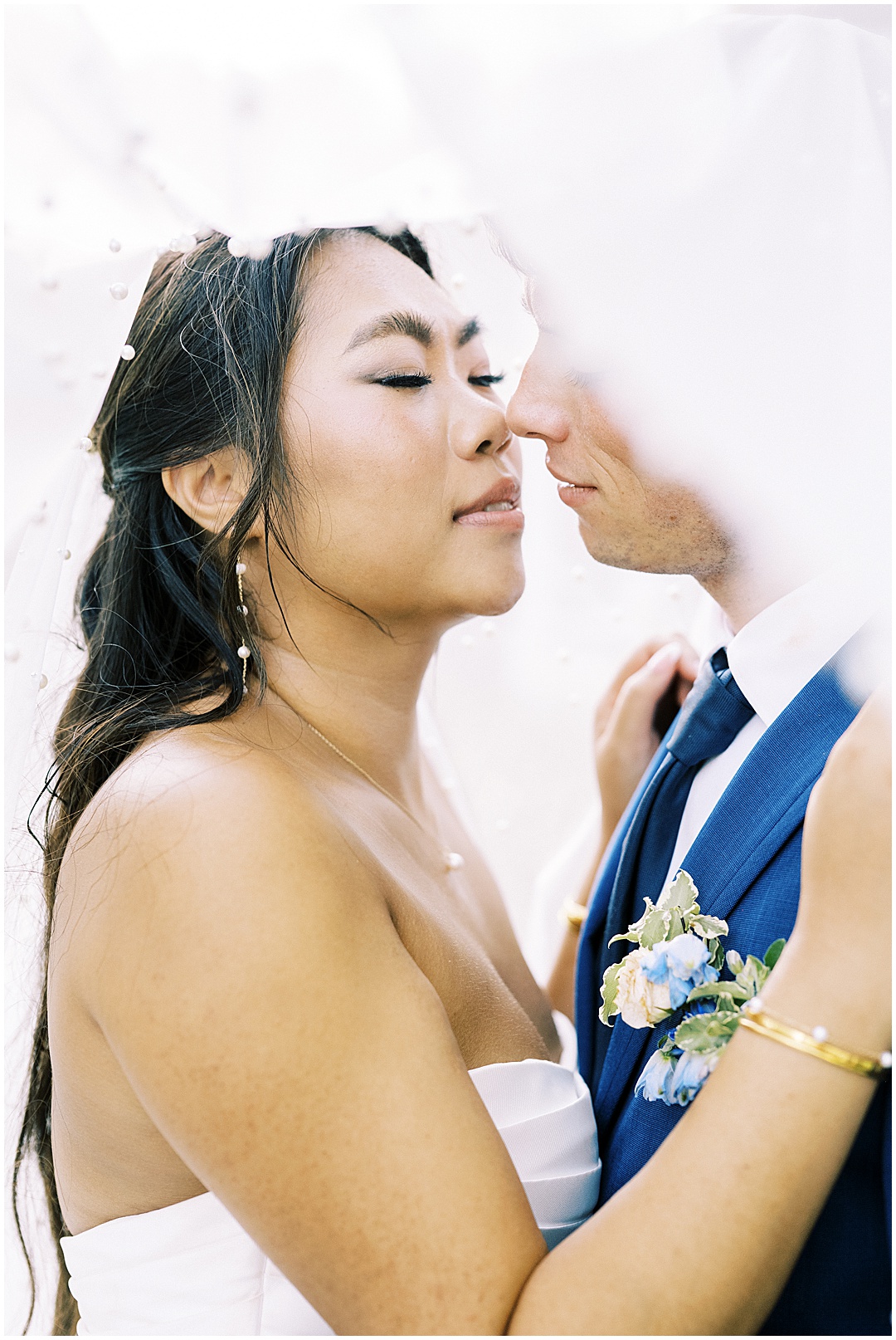 bride and groom portrait with veil