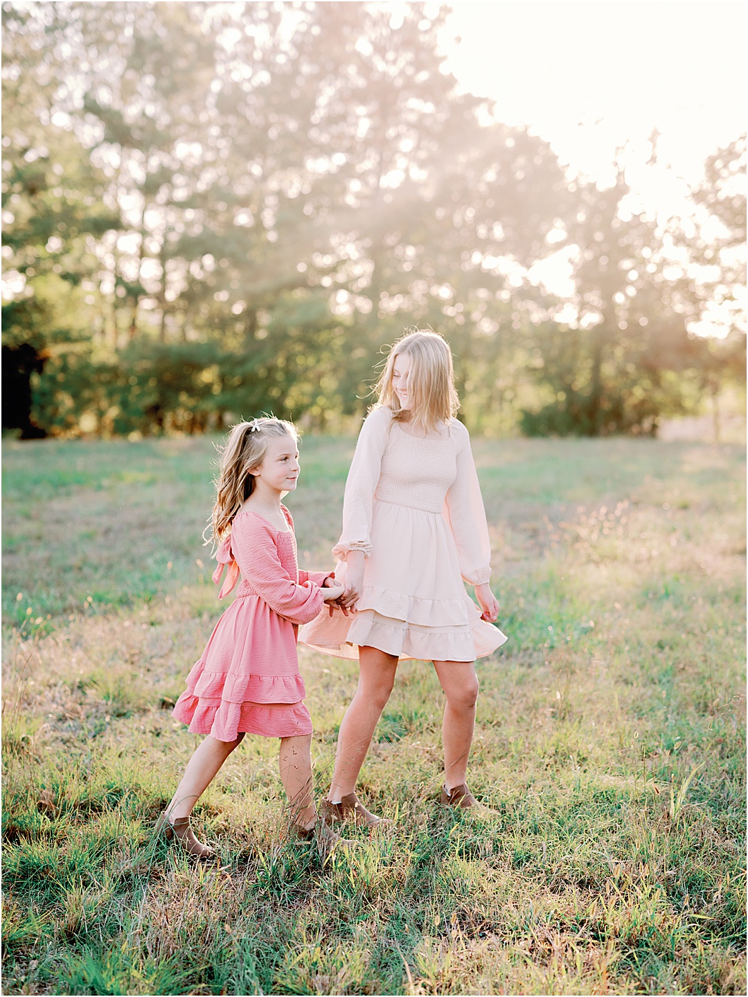 sisters holding hands and walking photo