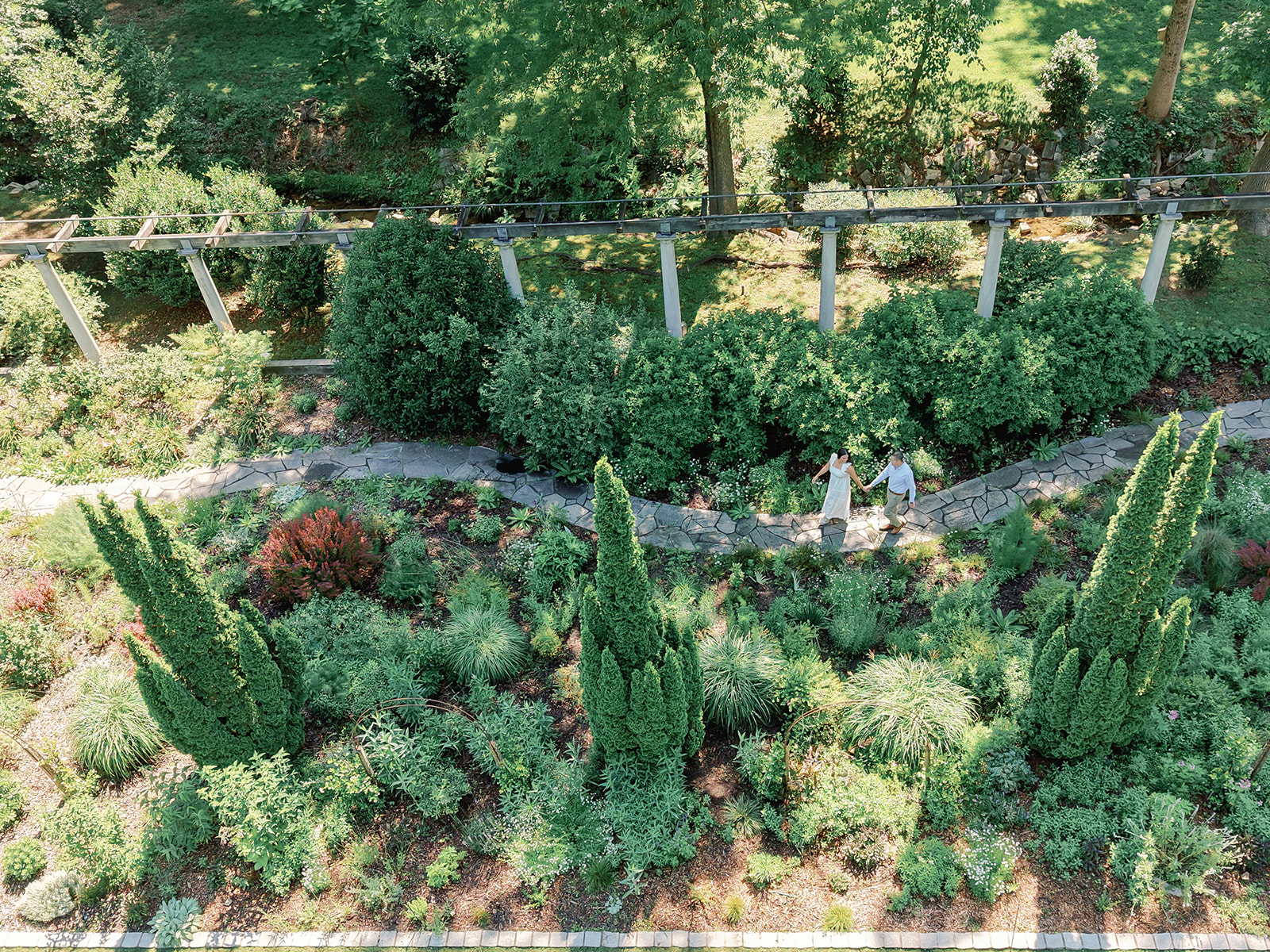 Engagement Photo Locations in Atlanta - 6 Outdoor Spaces for Stunning Photos - engagement photo locations in atlanta Engaged Couple Holds Hands and Walks Through Gardens at Cator Woolford