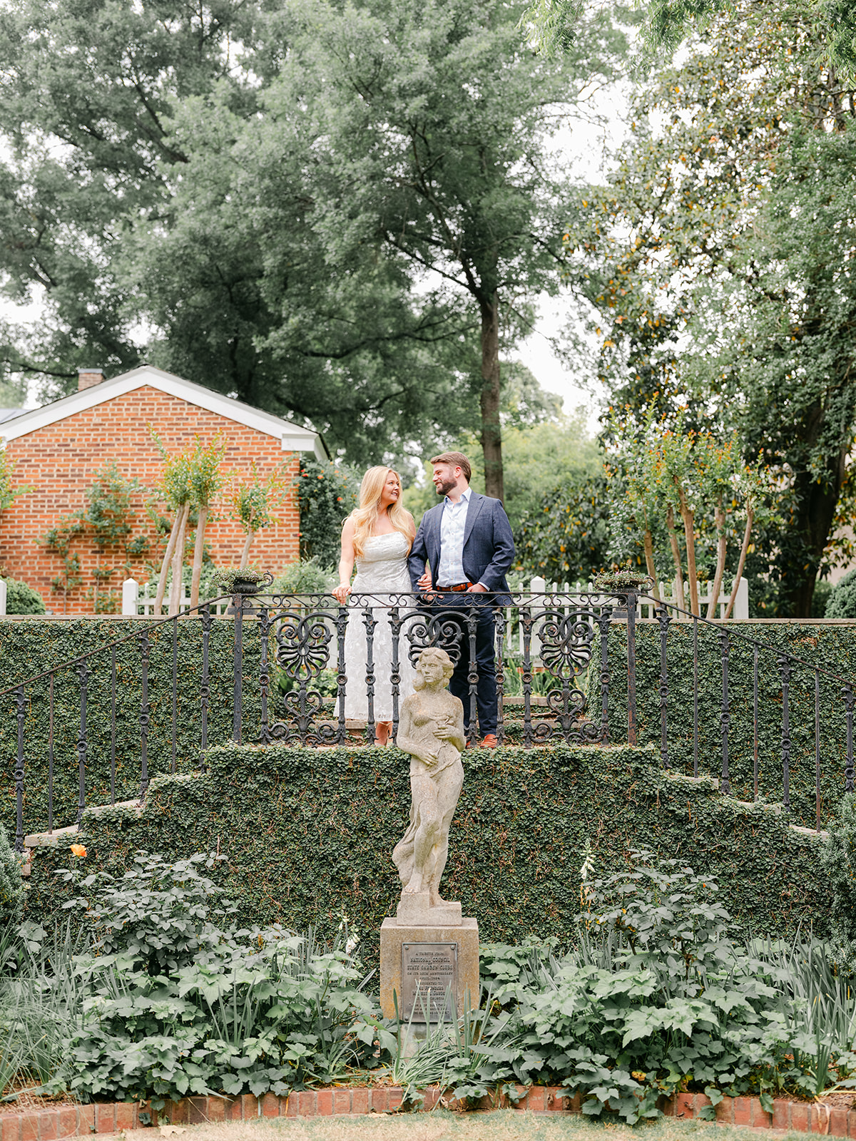 Engagement Photo Locations in Atlanta - 6 Outdoor Spaces for Stunning Photos - engagement photo locations in atlanta Couple Pose in Front of Stone Statue at UGA Founders Garden