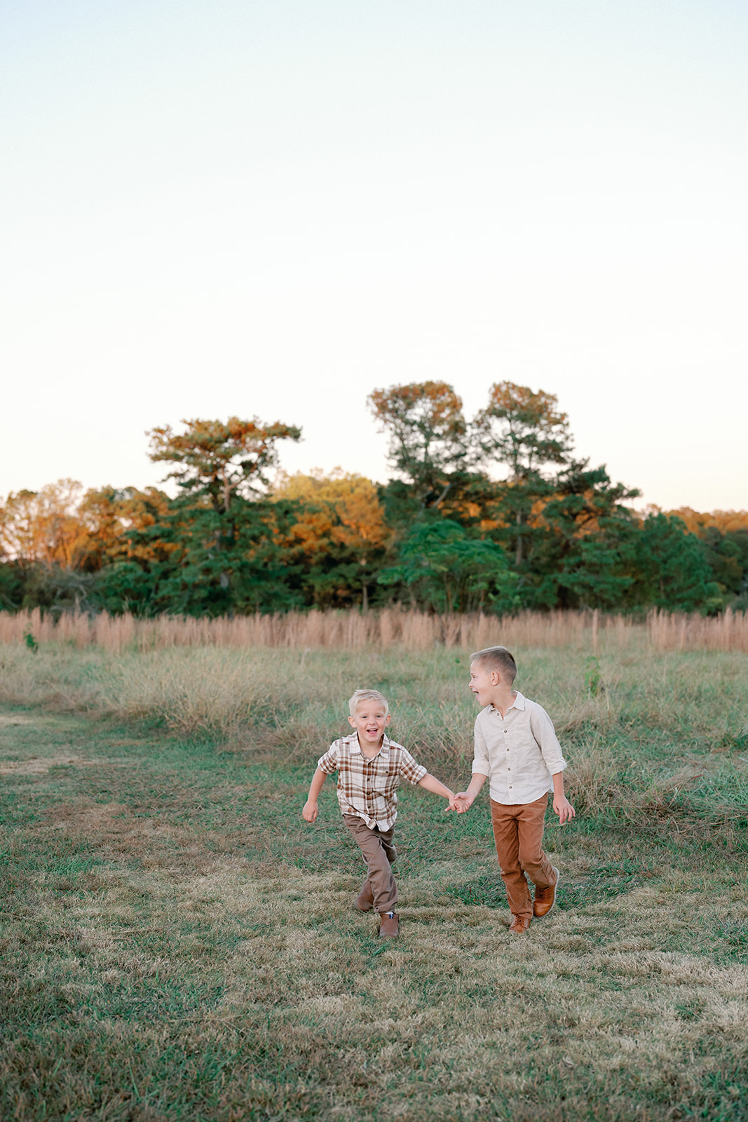 Fall Family Photos Atlanta - Mini Sessions - family photos atlanta Brothers Holding Hands Running Through Field During Photoshoot