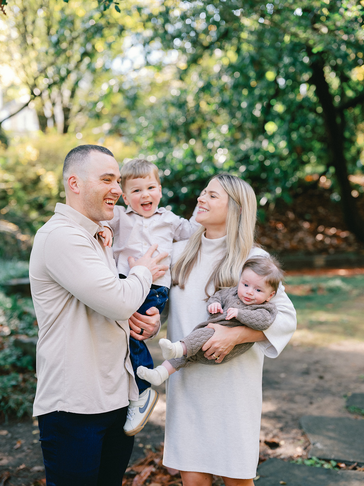 Fall Family Photos Atlanta - Mini Sessions - family photos atlanta Mom and Dad Holding Children in Park for Fall Family Photoshoot