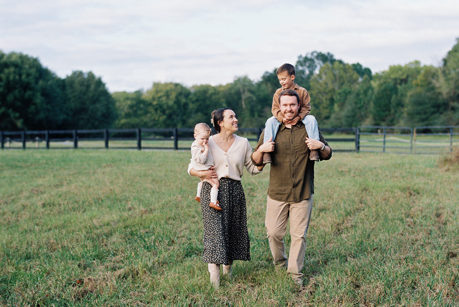 Fall Family Photos Atlanta - Mini Sessions - family photos atlanta Mom and Dad with Young Children Walking Through Field for Fall Photography