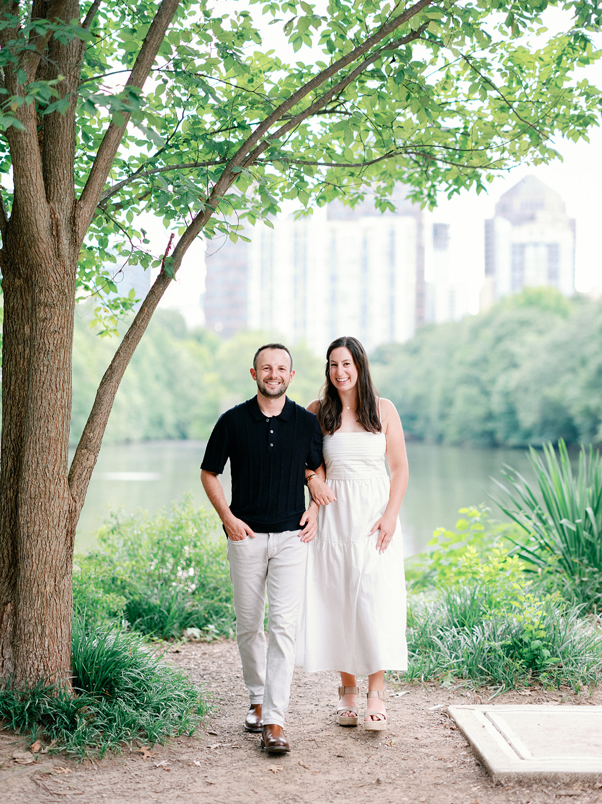 Engagement Photo Locations in Atlanta - 6 Outdoor Spaces for Stunning Photos - engagement photo locations in atlanta Couple Pose in Front of Lake at Piedmont Park for Engagement Photos