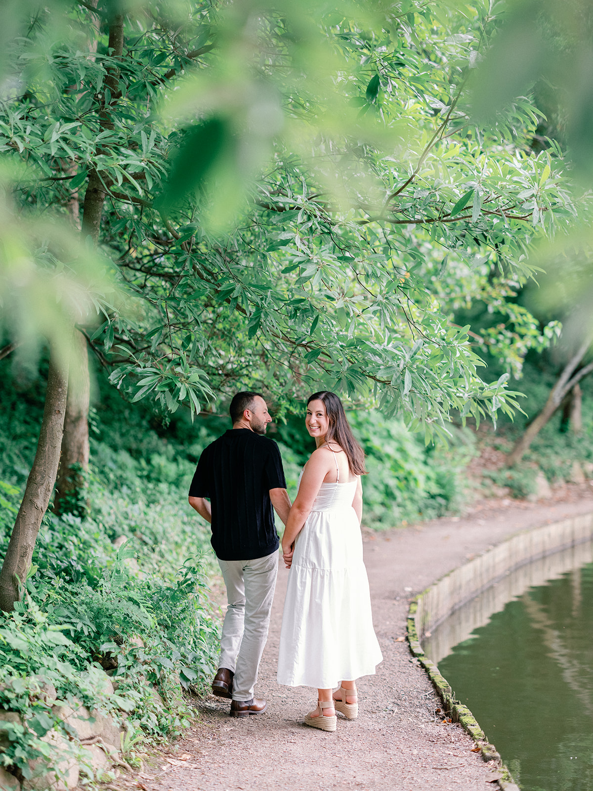 Engagement Photo Locations in Atlanta - 6 Outdoor Spaces for Stunning Photos - engagement photo locations in atlanta Engaged Couple Holds Hands and Walks Along Banks of River, Piedmont Park