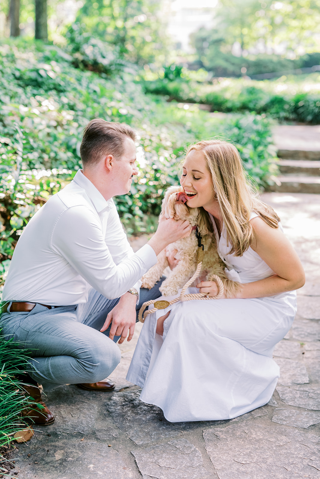 Engagement Photo Locations in Atlanta - 6 Outdoor Spaces for Stunning Photos - engagement photo locations in atlanta Couple Playfully Embrace with Puppy During Photoshoot for Engagement