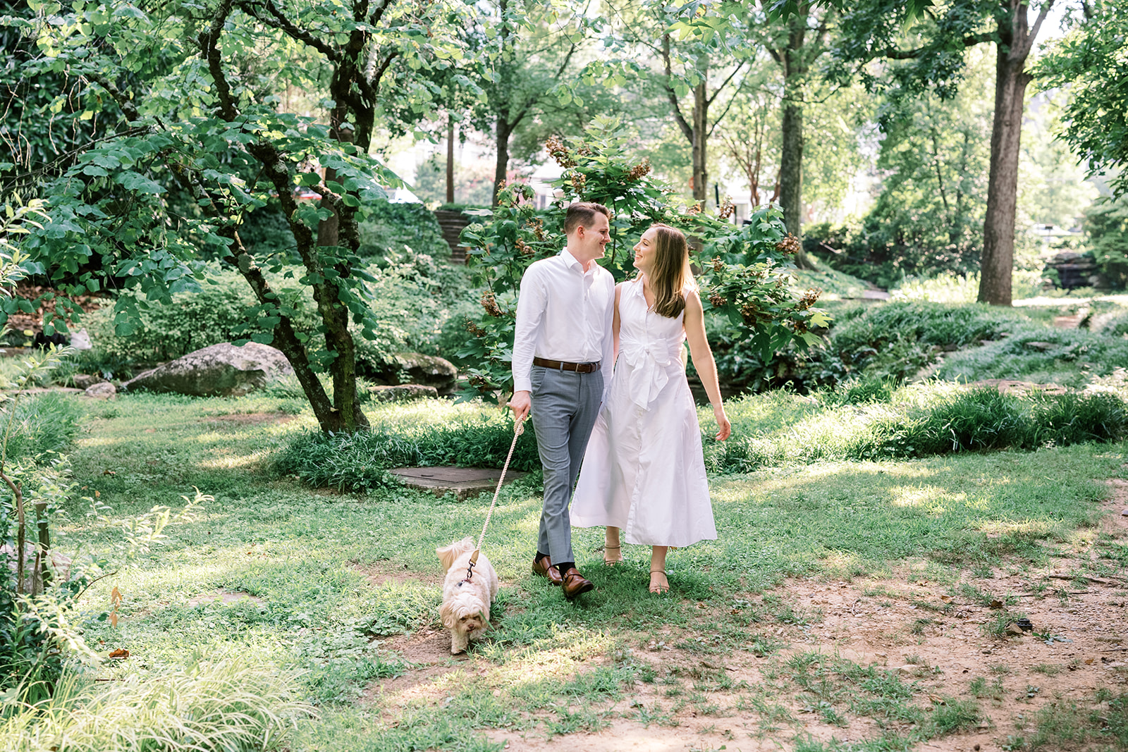 Engagement Photo Locations in Atlanta - 6 Outdoor Spaces for Stunning Photos - engagement photo locations in atlanta Couple Walk in Park with Dog on Leash in Winn Park for Engagement Photoshoot